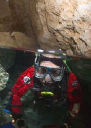 Freshwater cave, South Australia. Diver surfacing into ai... by Richard Harris 